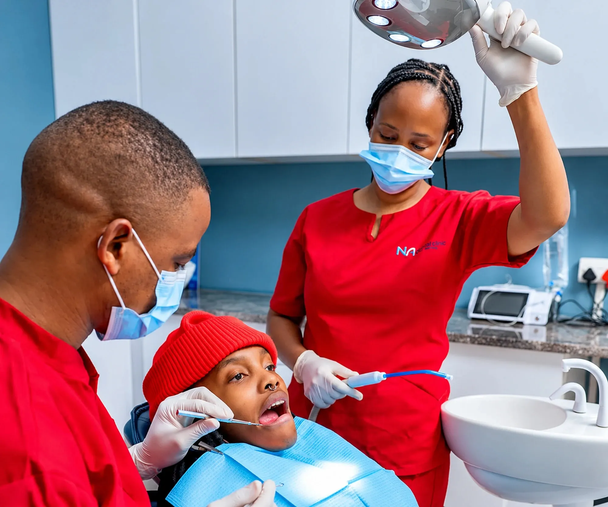 NewAge Clinic dentist and assistant treating a patient